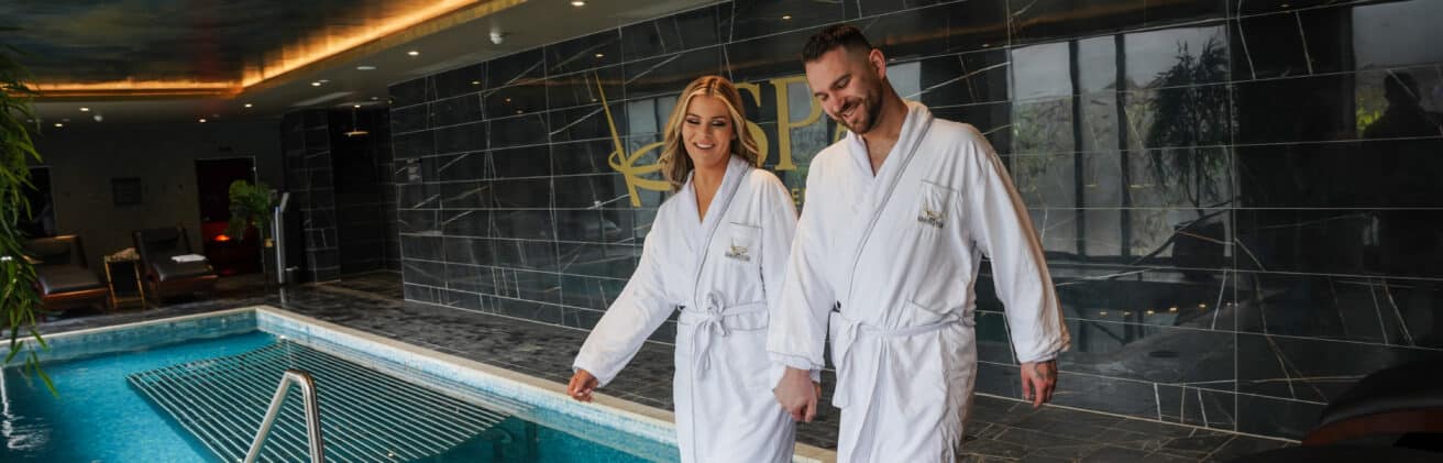 Couple walking by the pool in the Ebrington Hotel Spa